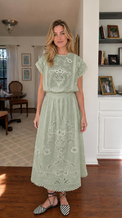 Woman wearing sage green embroidered short sleeve midi dress