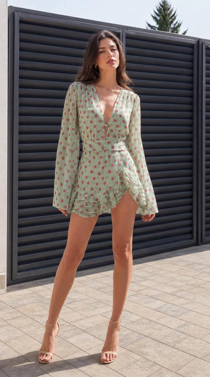 Full front view of model wearing sage green floral mini dress