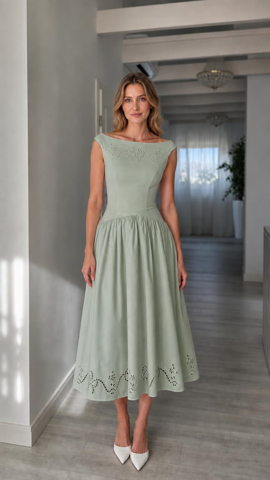 Full view of woman wearing sage green boatneck midi dress