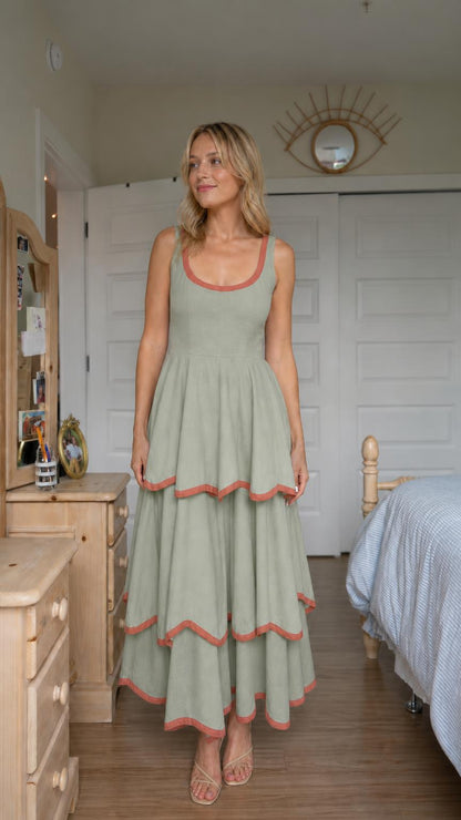 Front view of woman wearing sage green tiered maxi dress
