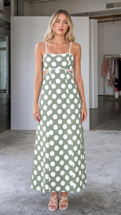 Front view of woman wearing sage green polka dot maxi dress