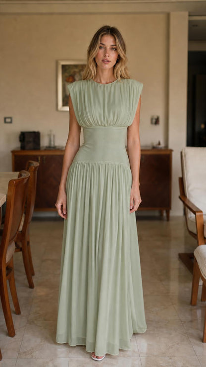Front view of woman wearing sage green pleated maxi dress