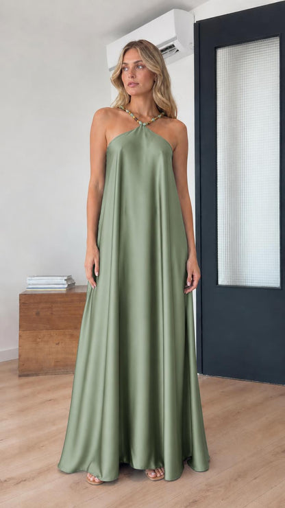 Model wearing sage green satin halter maxi dress