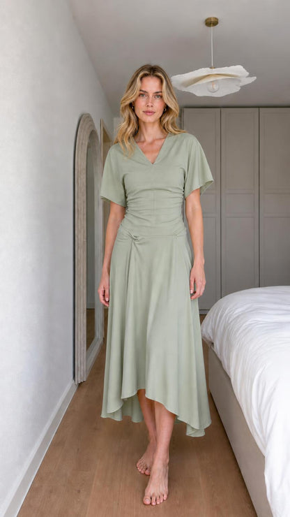 Front view of woman wearing sage green v-neck knot midi dress