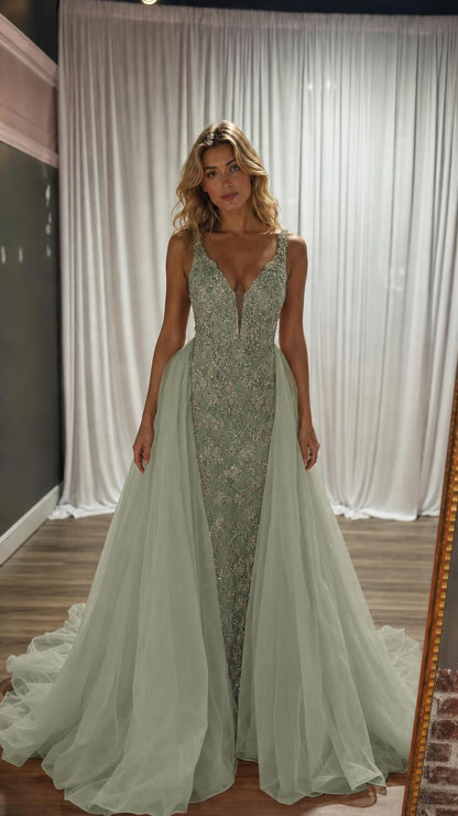 Model wearing sage green beaded evening gown with matching tulle train