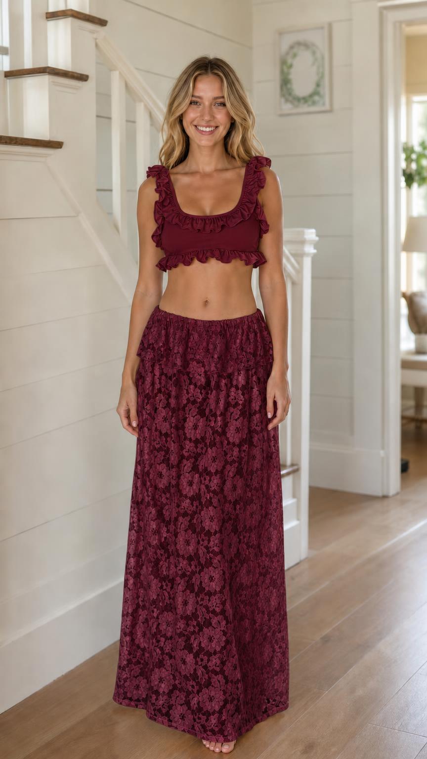 Model wearing burgundy ruffled crop top and lace maxi skirt set