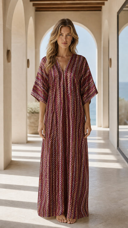 Front view of woman wearing burgundy chevron kaftan dress