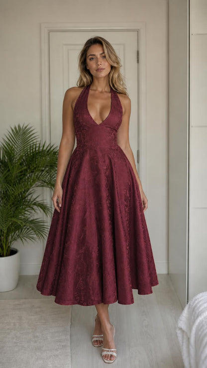 Model wearing burgundy halter midi dress