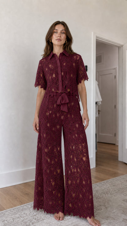 Woman wearing burgundy floral lace shirt and wide-leg pants set