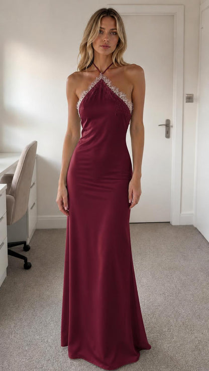 Model wearing burgundy halter neck lace trim satin maxi dress