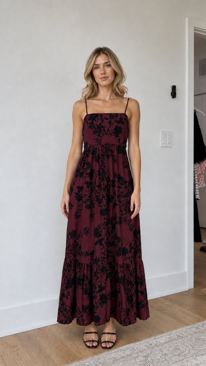 Model wearing burgundy floral maxi dress