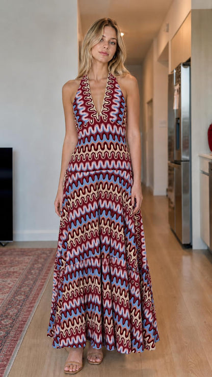 Model wearing burgundy multi wave pattern halter maxi dress