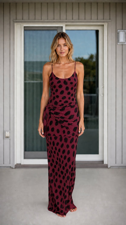 Front view of woman wearing burgundy polka dot maxi dress