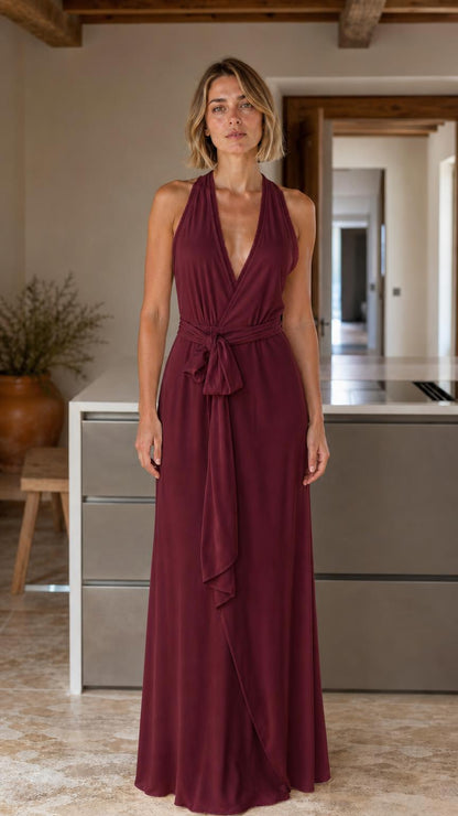Front view of woman wearing burgundy halter v-neck maxi dress