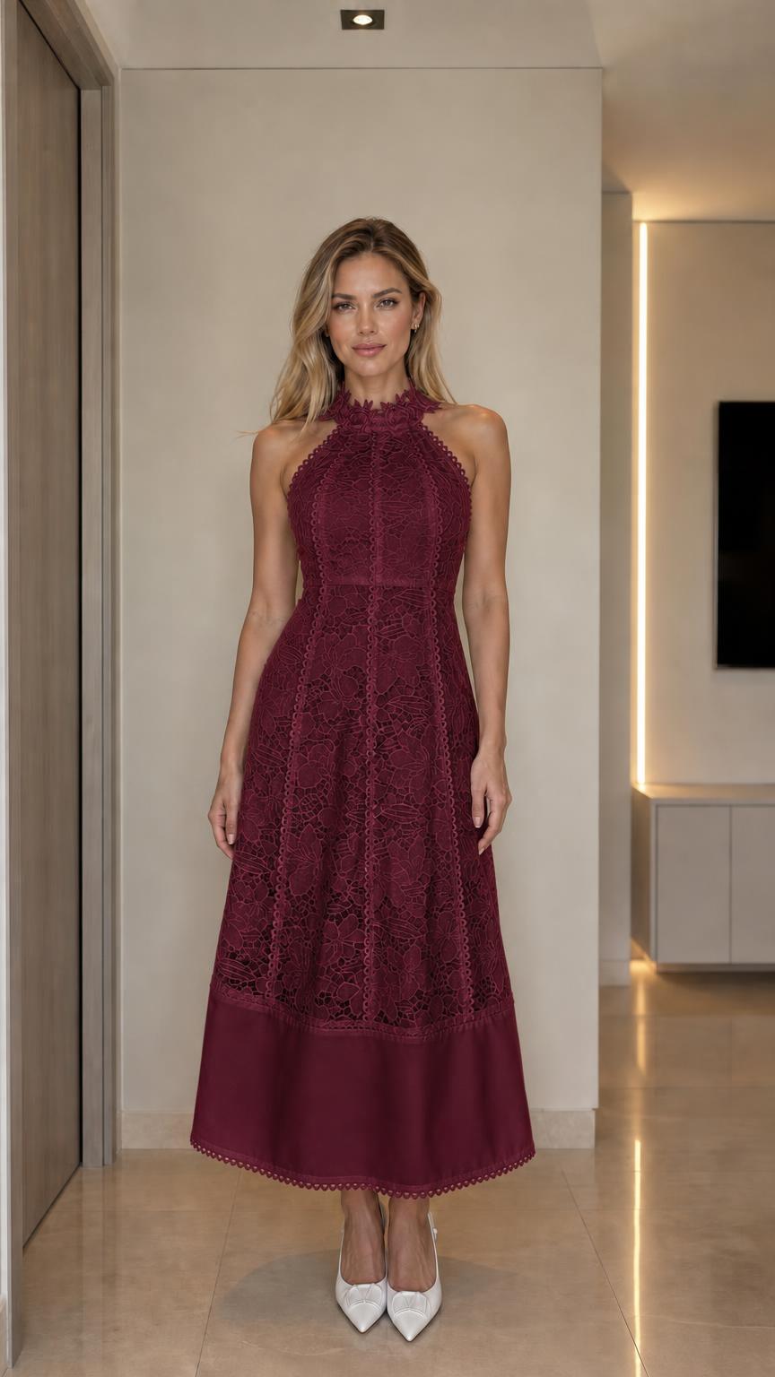 Front view of woman wearing burgundy halter neck lace midi dress