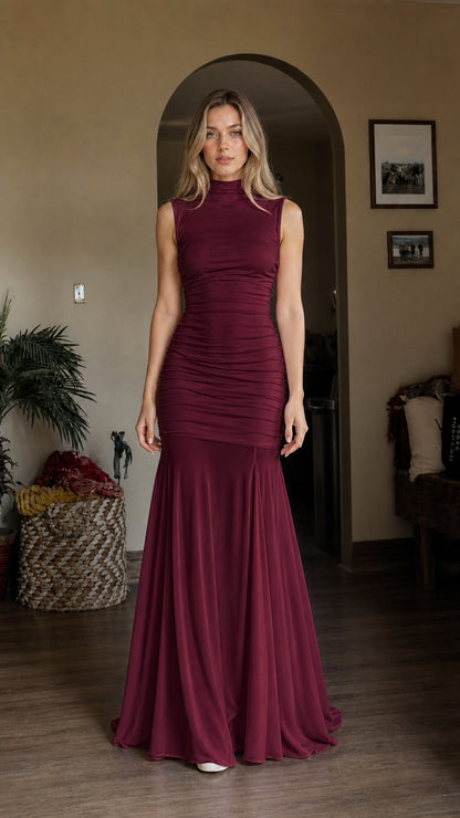 Model wearing burgundy high neck ruched mermaid dress