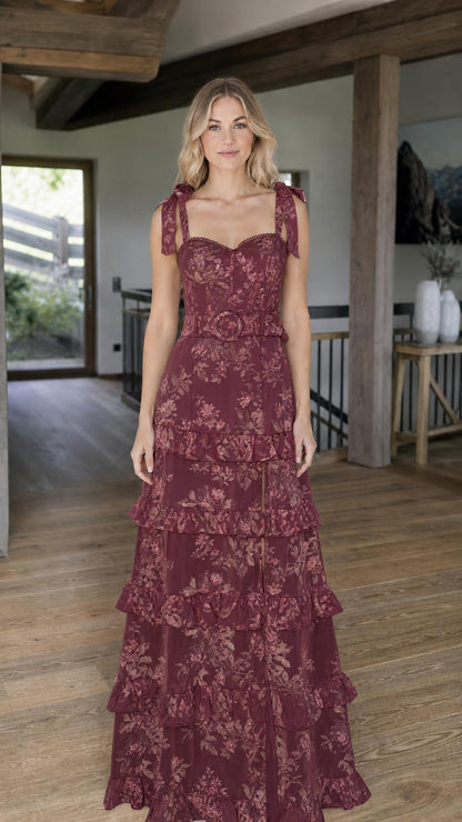 Model wearing burgundy floral print tiered maxi dress