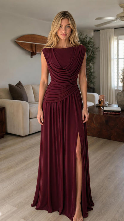 Model wearing burgundy cowl neck maxi dress with high slit