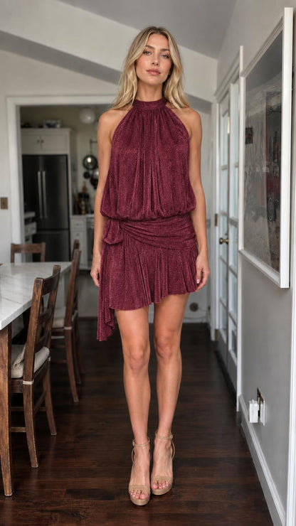 Model wearing burgundy metallic halter mini dress