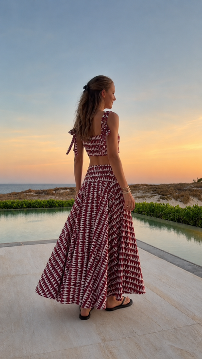 Back view of burgundy printed two-piece crop top and maxi skirt set