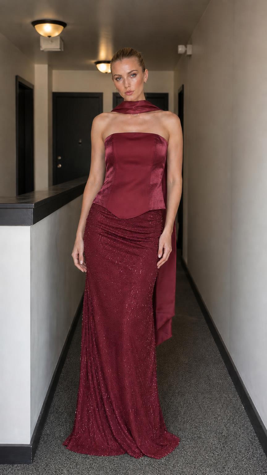 Model wearing burgundy evening gown set with corset bodice