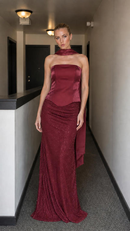Model wearing burgundy evening gown set with corset bodice
