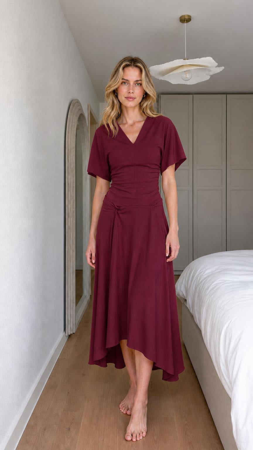 Front view of woman wearing burgundy v-neck knot midi dress