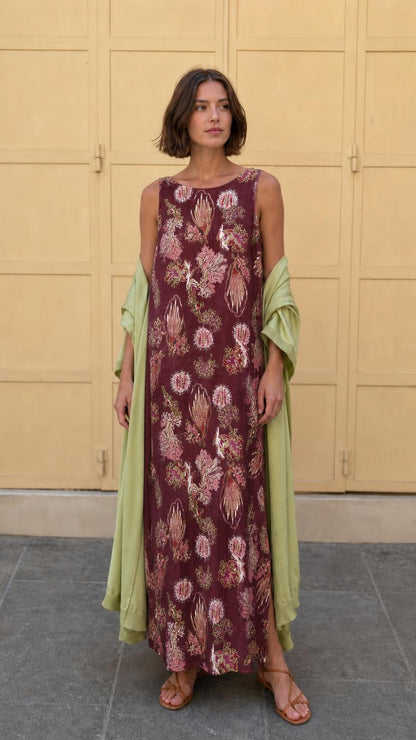 Model wearing burgundy floral print sleeveless maxi dress with matching wrap