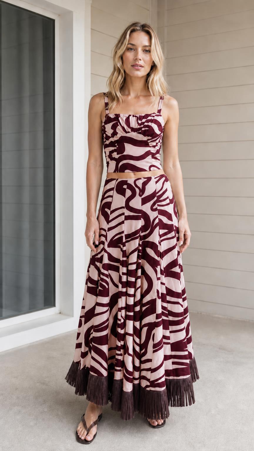 Model wearing burgundy zebra print crop top and maxi skirt set