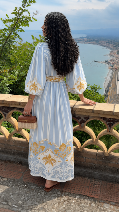 Back view of sky blue bohemian print maxi dress with flowing silhouette