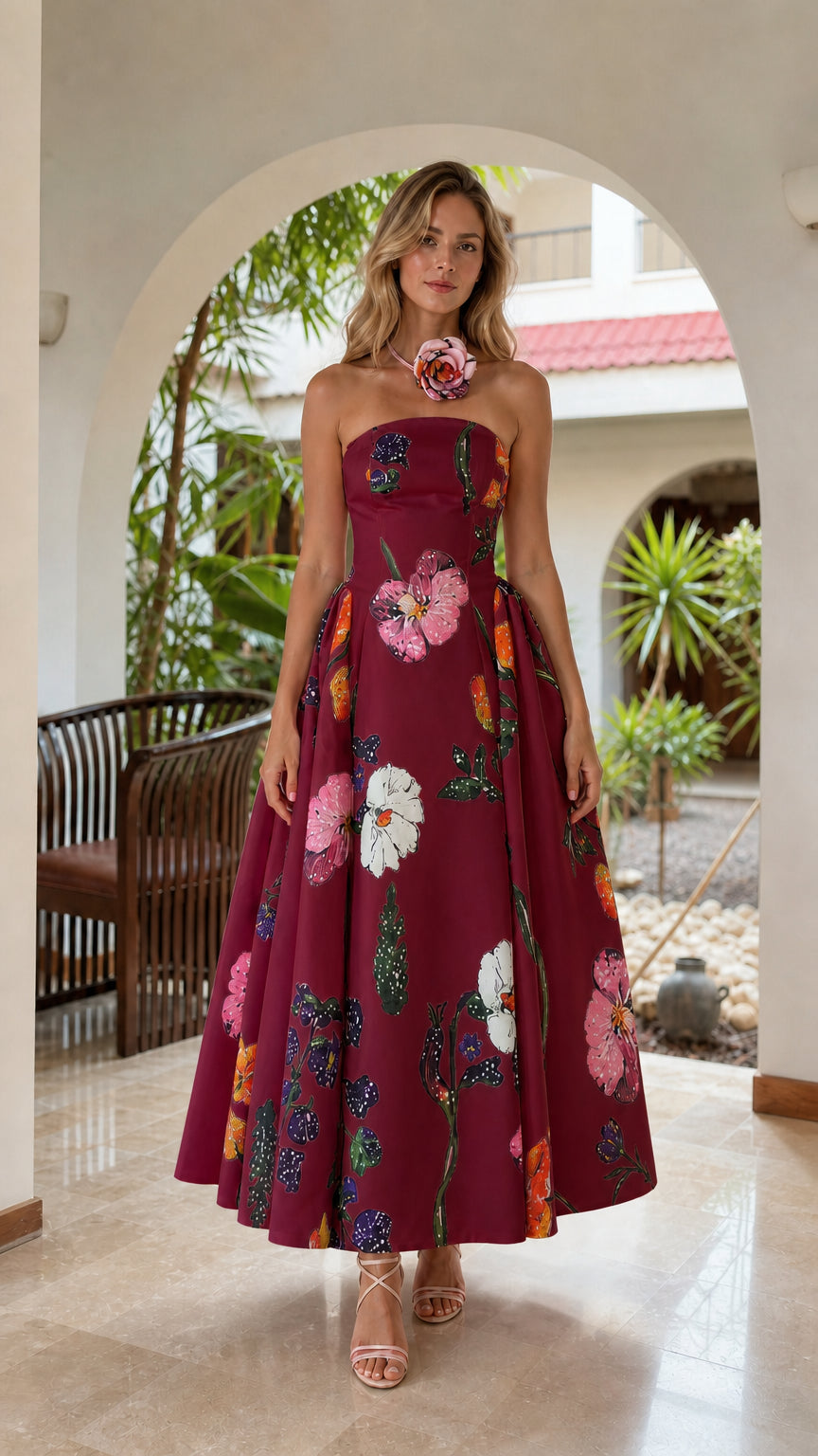 Model wearing burgundy floral strapless midi dress