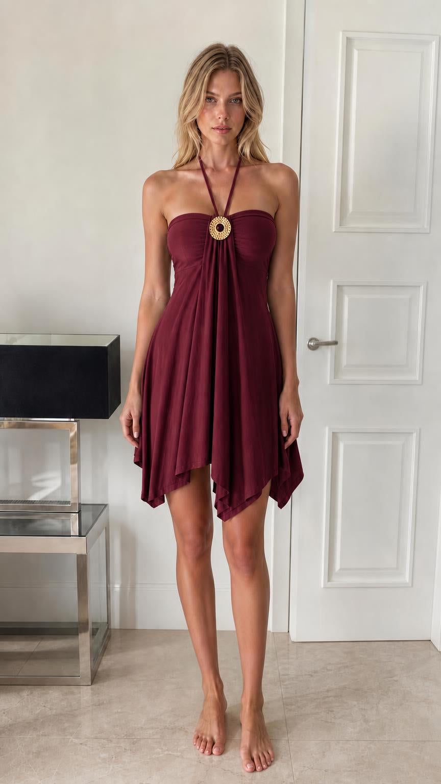 Front view of model wearing burgundy halter mini dress