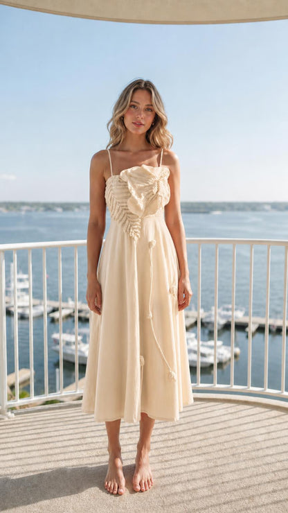 Front view of woman wearing beige ruffled midi dress