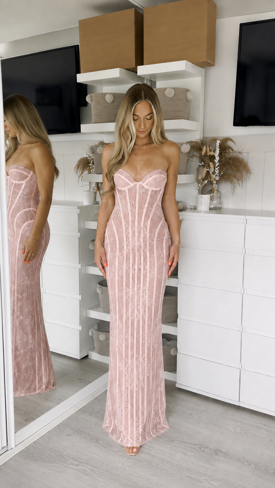 Woman wearing pink strapless lace corset maxi dress front view