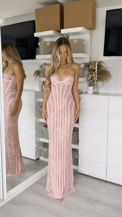Woman wearing pink strapless lace corset maxi dress front view