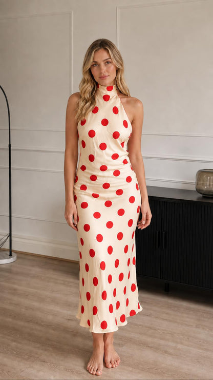 Model wearing cream and red polka dot halter midi dress