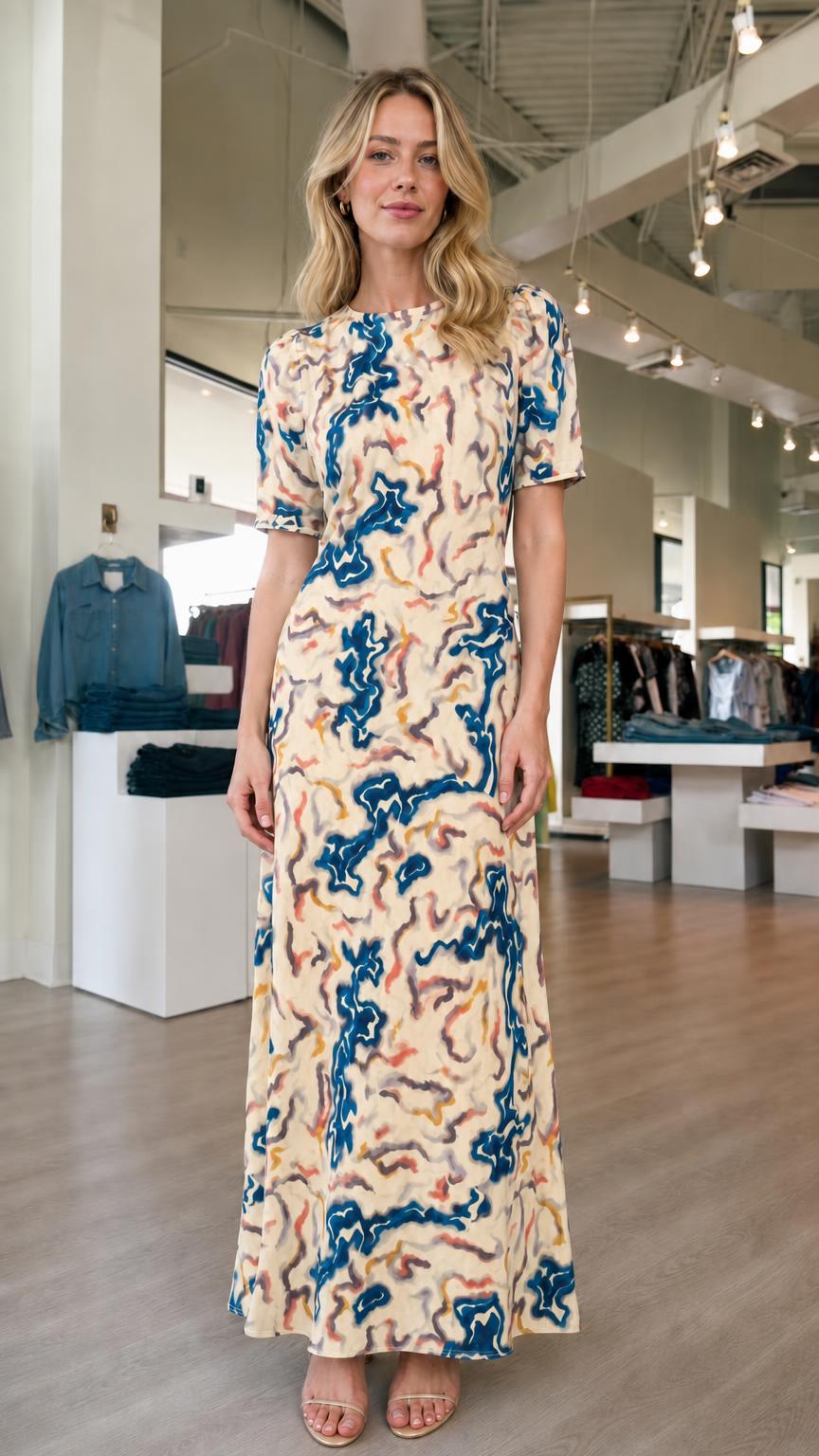 Front view of model wearing cream abstract print maxi dress