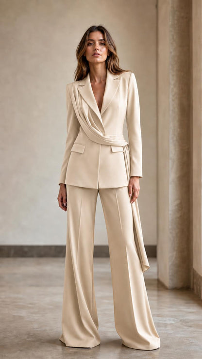 Front view of woman wearing beige draped blazer and wide-leg pants suit