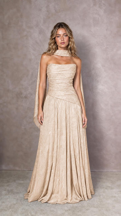 Front view of model wearing champagne strapless evening dress