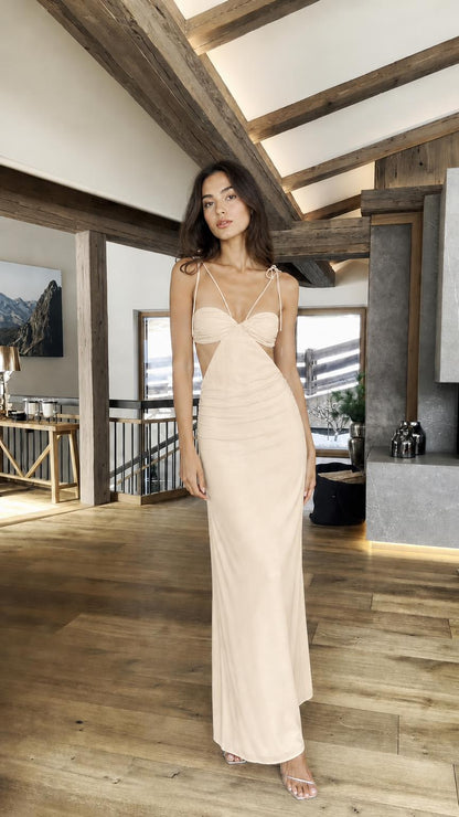 Model wearing champagne cutout halter maxi dress