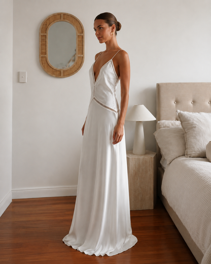 Side view of ivory satin-style maxi dress with plunging neckline