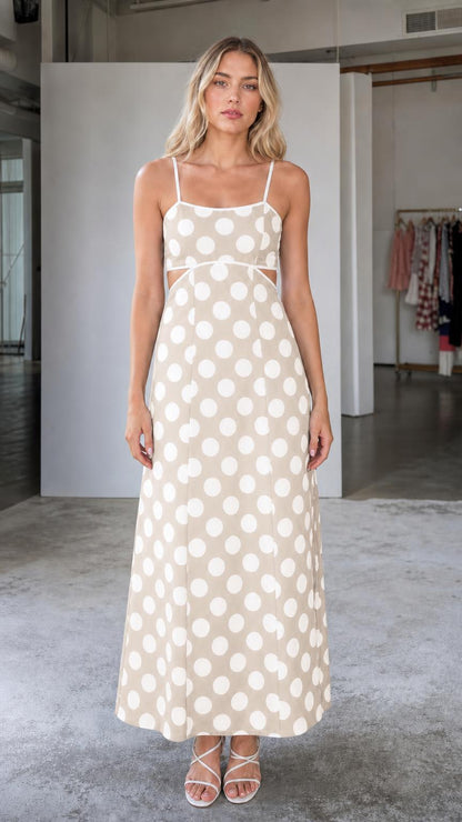 Front view of woman wearing beige polka dot maxi dress