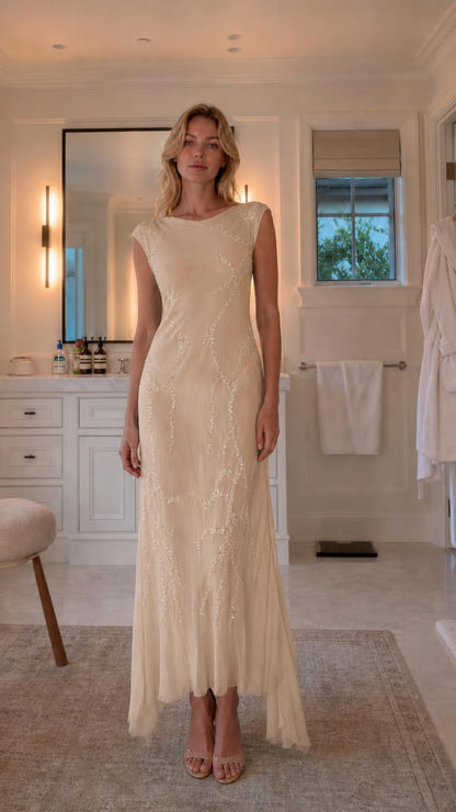 Front view of model wearing champagne sequin maxi dress