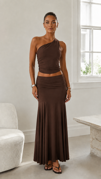 Front view of espresso brown one-shoulder ruched crop top and maxi skirt set