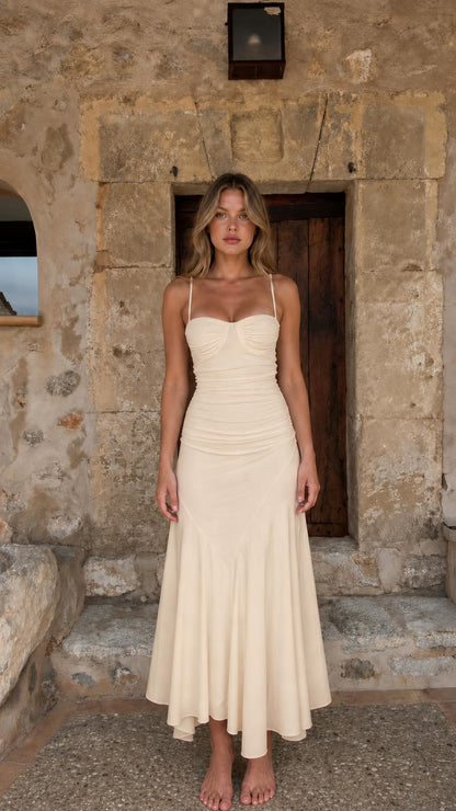 Full-body view of woman in cream ruched midi dress